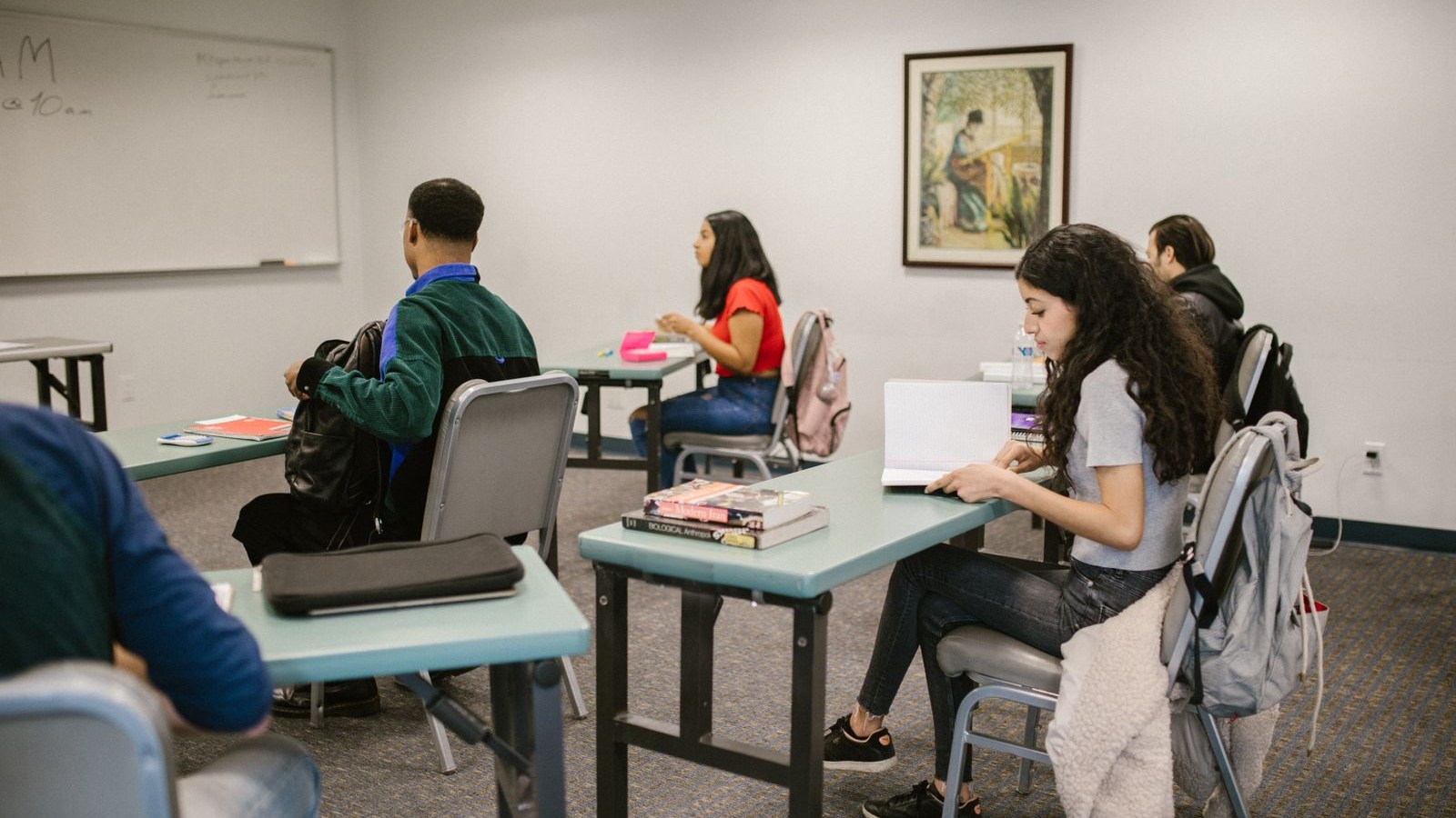 A community college course catalog open beside a printed short-course flyer