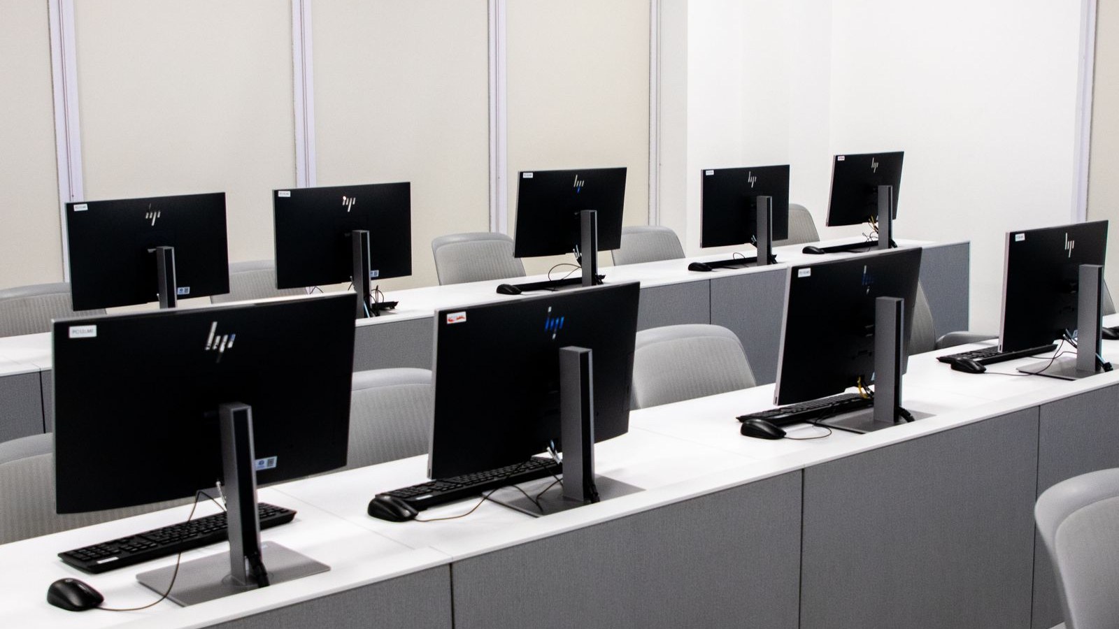 A row of public computer terminals and a check-in desk in a government office