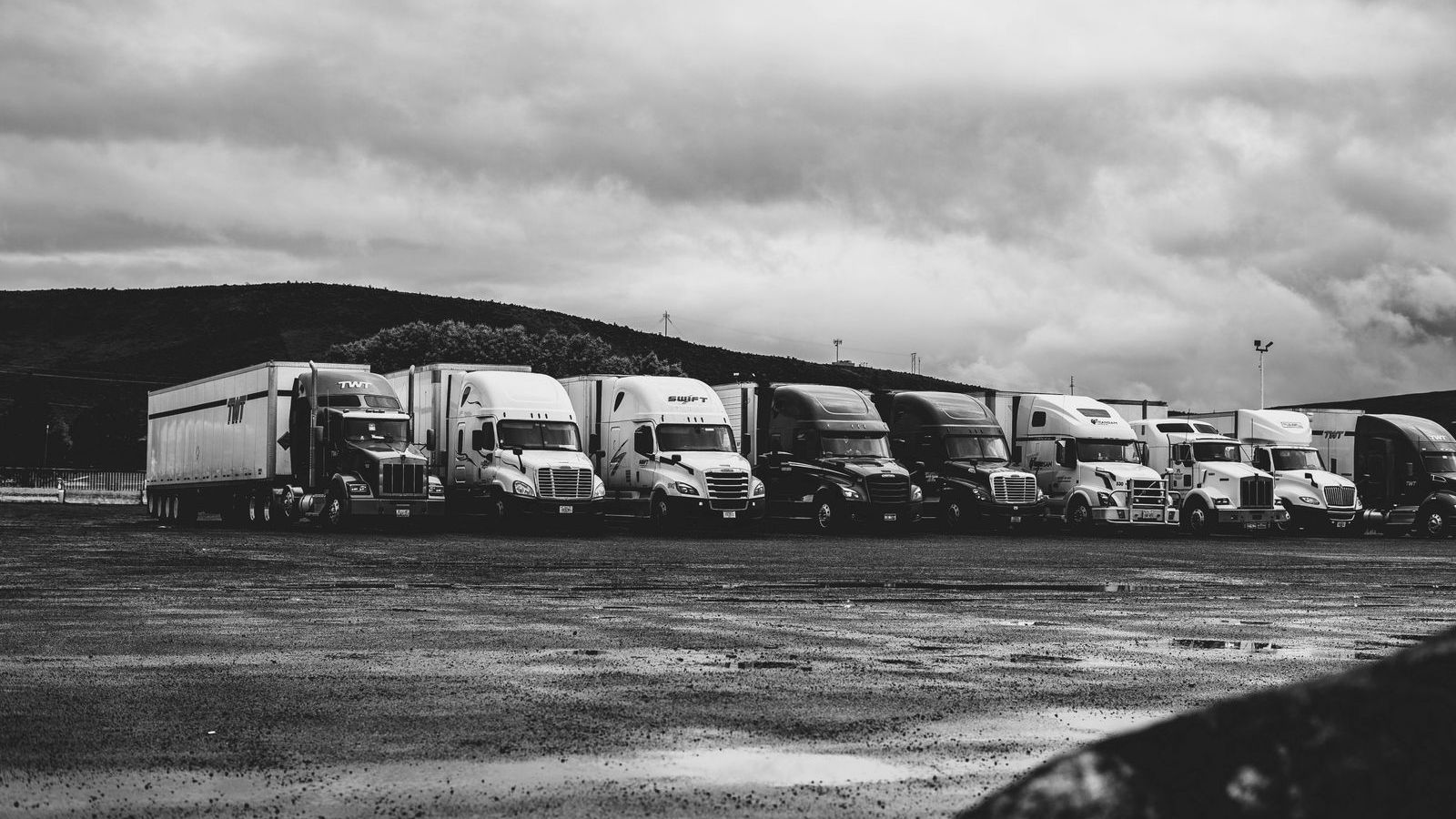 A tractor-trailer parked in a training yard with cones set out for backing practice